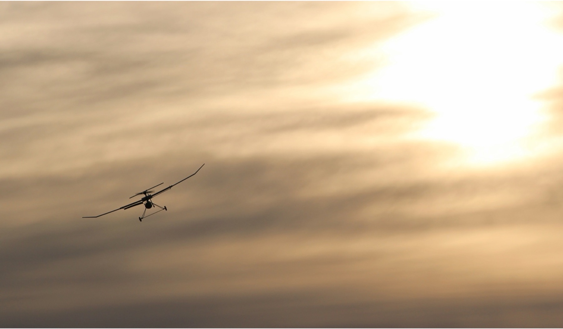 The VAST UAV silhouetted against a golden sunset
